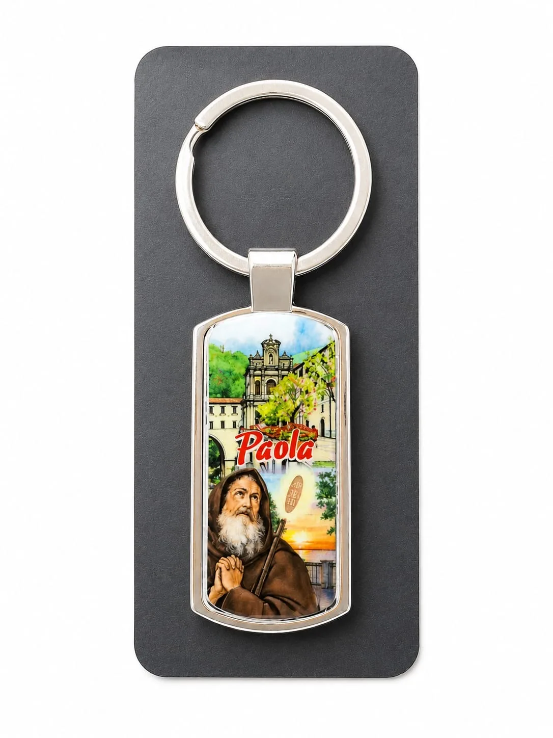 Portachiavi metallo argentato con santuario di Paola e San Francesco in preghiera su sfondo verde