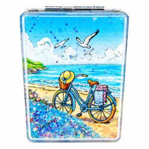 Specchietto rettangolare con bicicletta azzurra sulla spiaggia, mare turchese e glitter blu decorativi