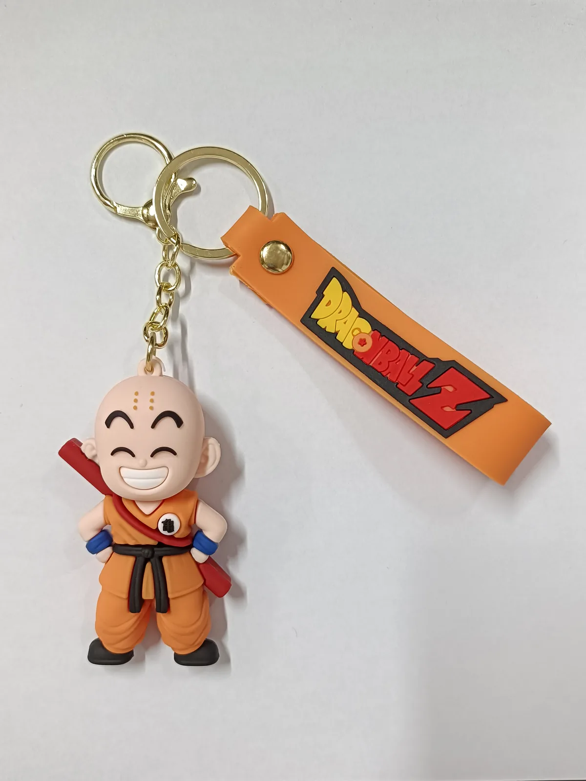 Portachiavi Dragon Ball Z con ciondolo Crilin in gomma 3D divisa arancione e targhetta logo