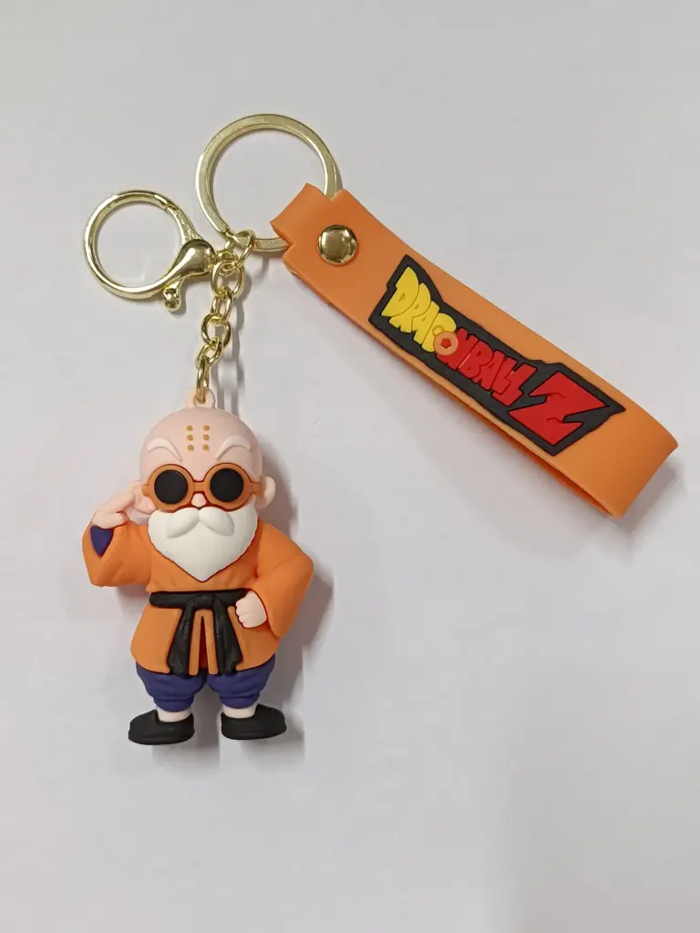 Portachiavi Dragon Ball Z con ciondolo Maestro Muten in gomma, kimono arancione e targhetta logo