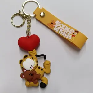 Portachiavi Garfield in gomma che abbraccia orsetto con cuore rosso e placchetta gialla