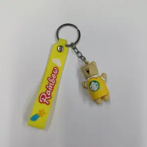 Portachiavi giallo con orsetto beige in maglietta Starbucks e ciondolo Rainbow decorato