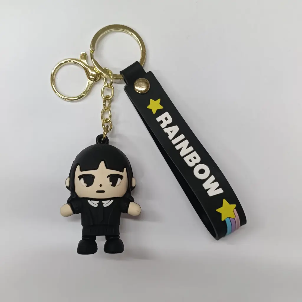 Portachiavi Mercoledì Addams con ciondolo in gomma e fascetta nera Rainbow con stelle gialle