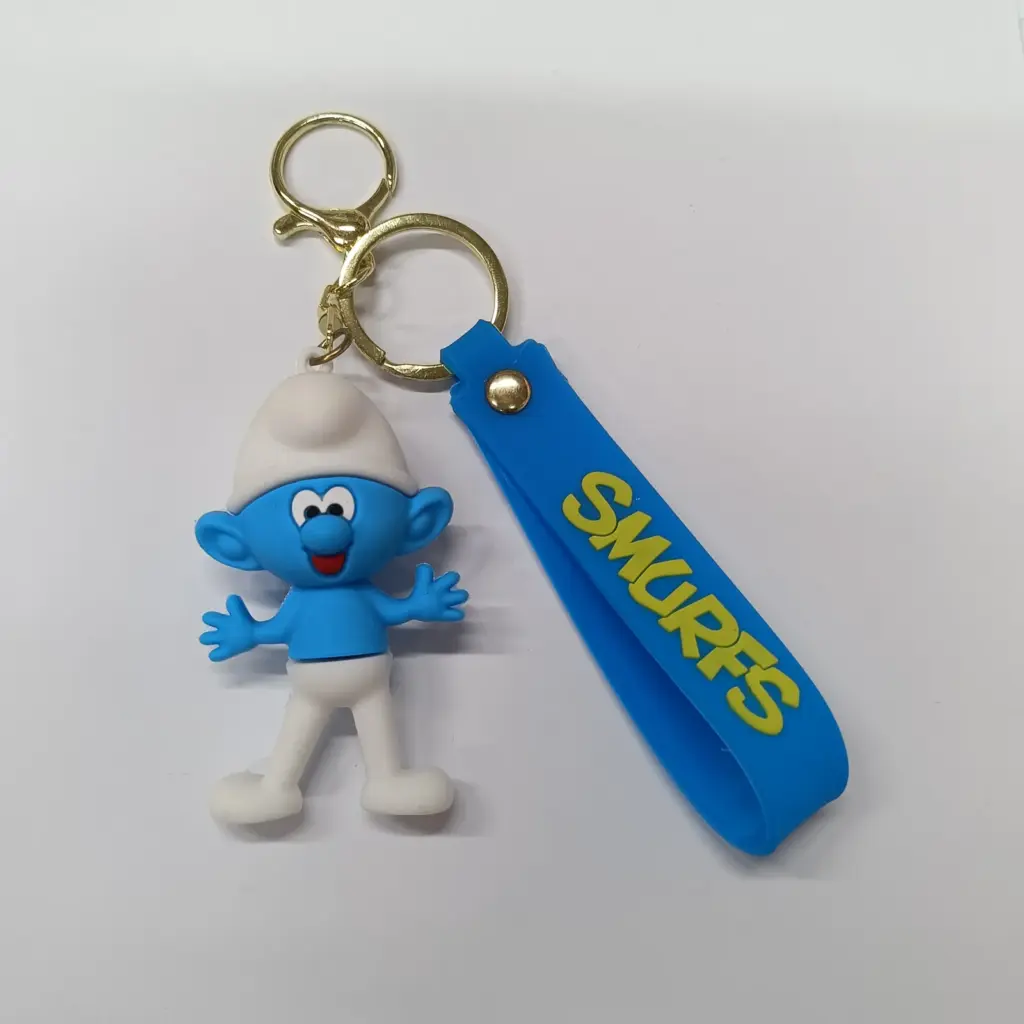 Portachiavi puffo in gomma blu con cappello bianco e targhetta SMURFS gialla