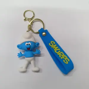 Portachiavi puffo in gomma blu con cappello bianco e targhetta SMURFS gialla