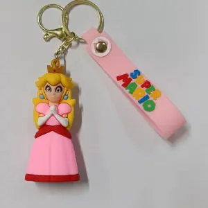 Portachiavi Super Mario con figura tridimensionale Principessa Peach abito rosa corona dorata cinturino gomma