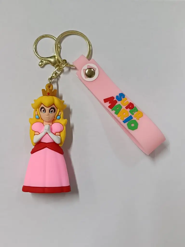 Portachiavi Super Mario con figura tridimensionale Principessa Peach abito rosa corona dorata cinturino gomma