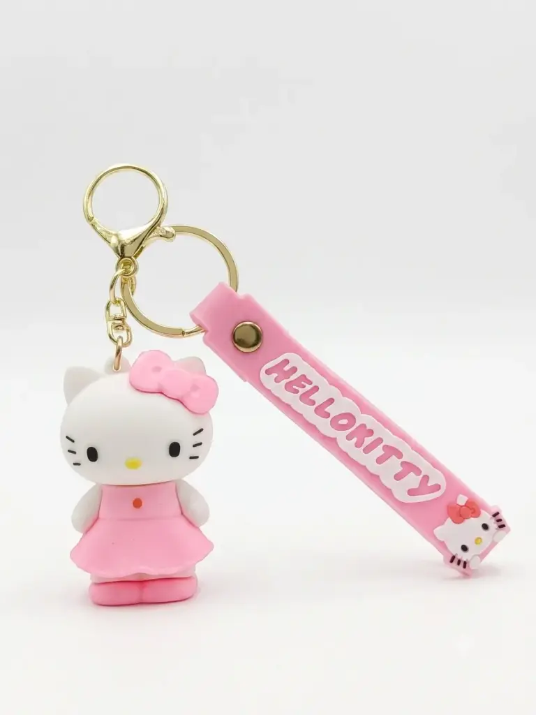 Portachiavi Hello Kitty con figura rosa in abito e fiocco, targhetta gommata rosa con scritta in rilievo e anello metallico dorato